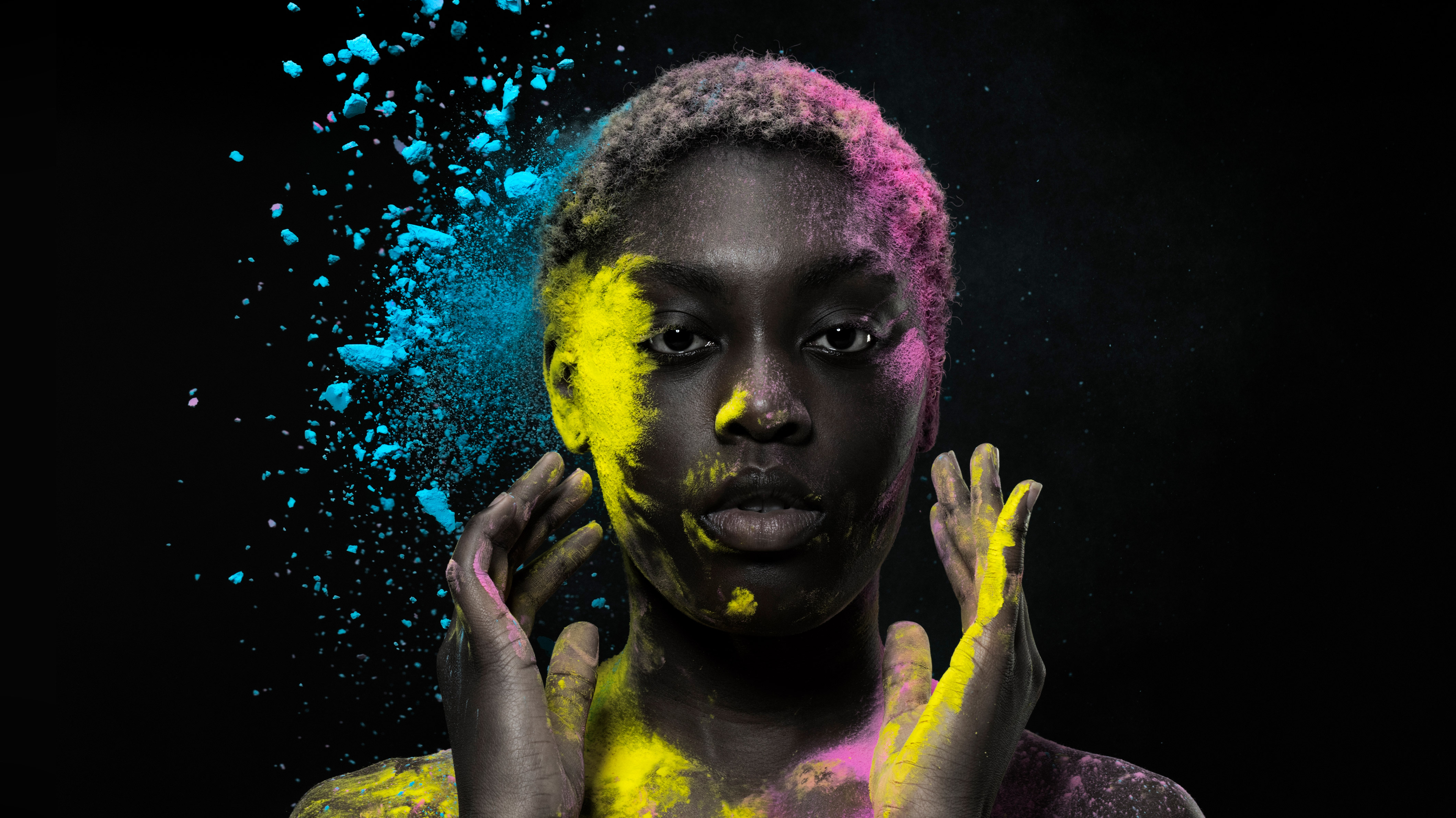 black woman posing with colorful powder